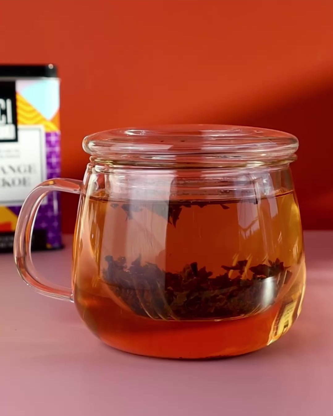 Orange Pekoe tea brewing in a glass infuser tea cup.